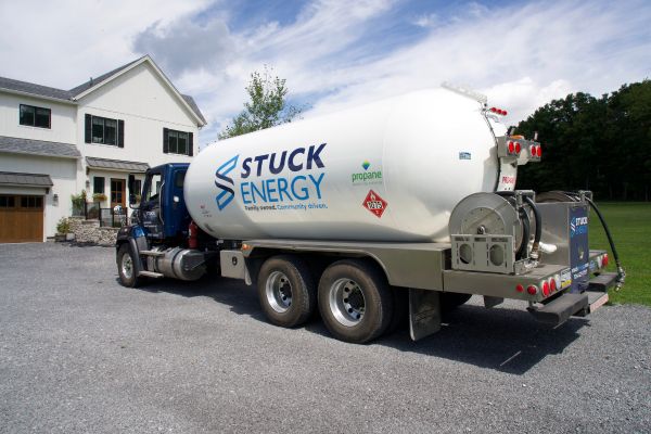 Stuck Energy propane delivery truck outside a house