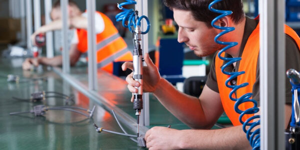 Men during precision work on production line depicting propane for manufacturing