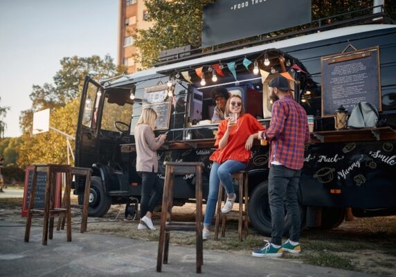 food truck with customers and chairs outside