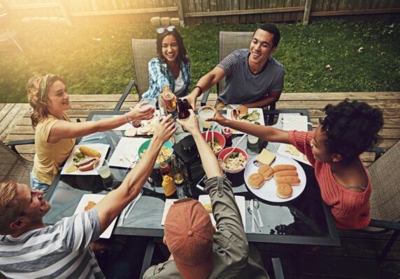 group of friends enjoying a meal in the backyard