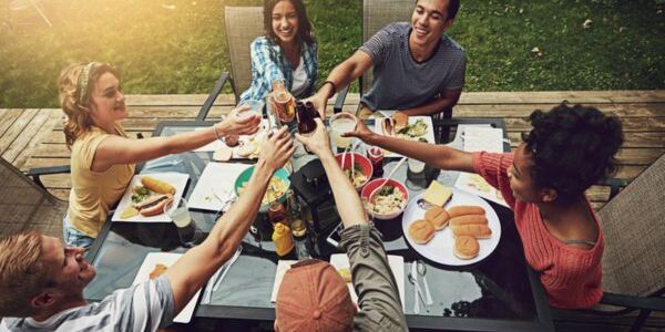 group of friends enjoying a meal in the backyard