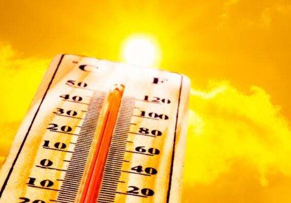 sunshine and thermometer depicting summer heat