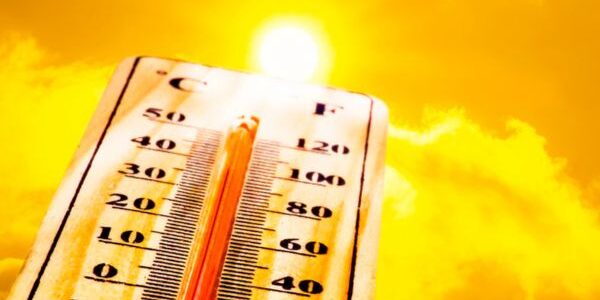 sunshine and thermometer depicting summer heat